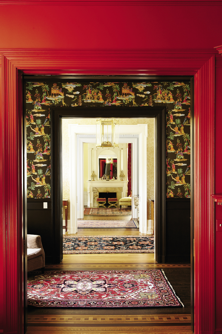 The view from the dining room to the formal living room crosses two anterooms and the foyer.