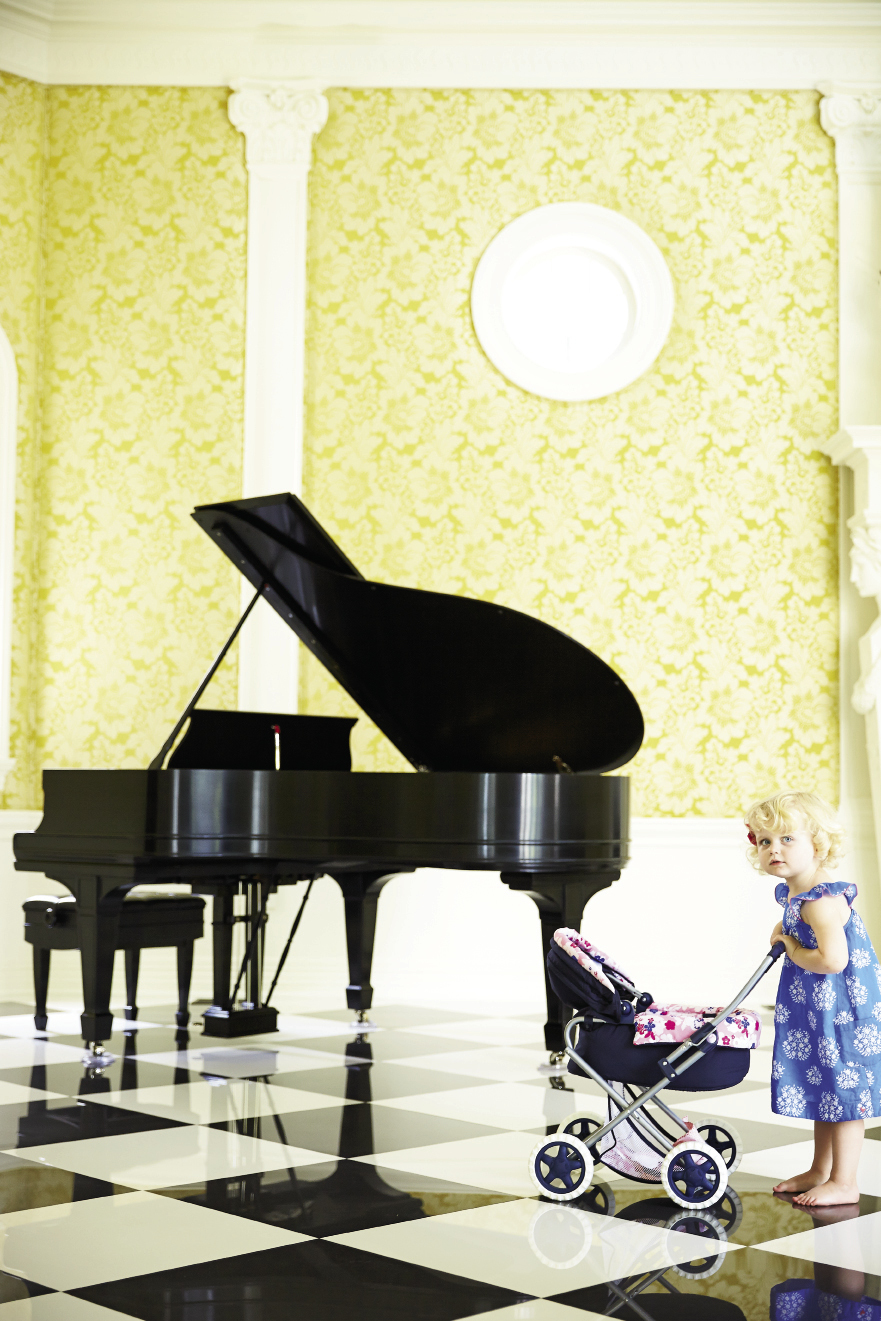 “The ballroom, with that volume and space, is pretty spectacular,” says Eddie Fava, but it suffered the most damage. Now polished and stately, the walls wear a fine Lee Jofa fabric, and a grand piano complements the marble floor.