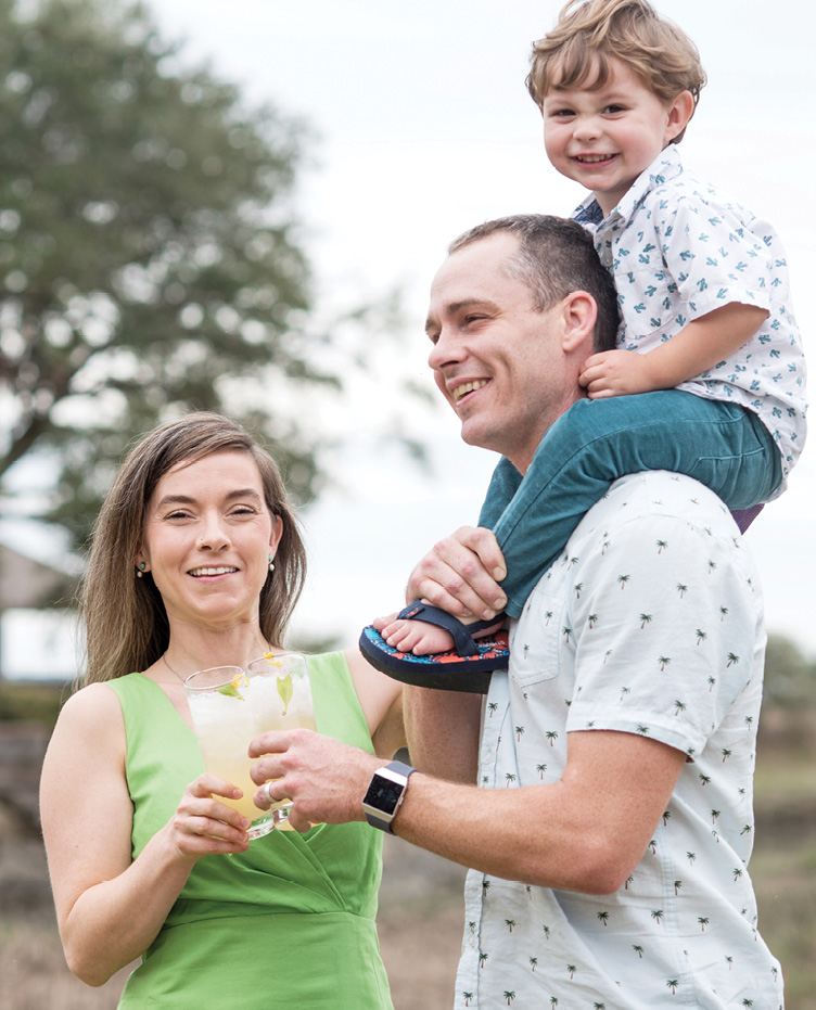 Mom and Dad toast grapefruit gin fizzes while two-year-old Dewey pals around.