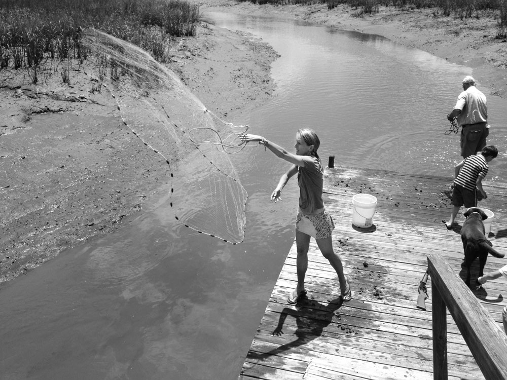 The author with her father; son; and parents’ chocolate Lab, Bones, on Garden Creek, a tributary of the Toogoodoo River, just south of Yonges Island