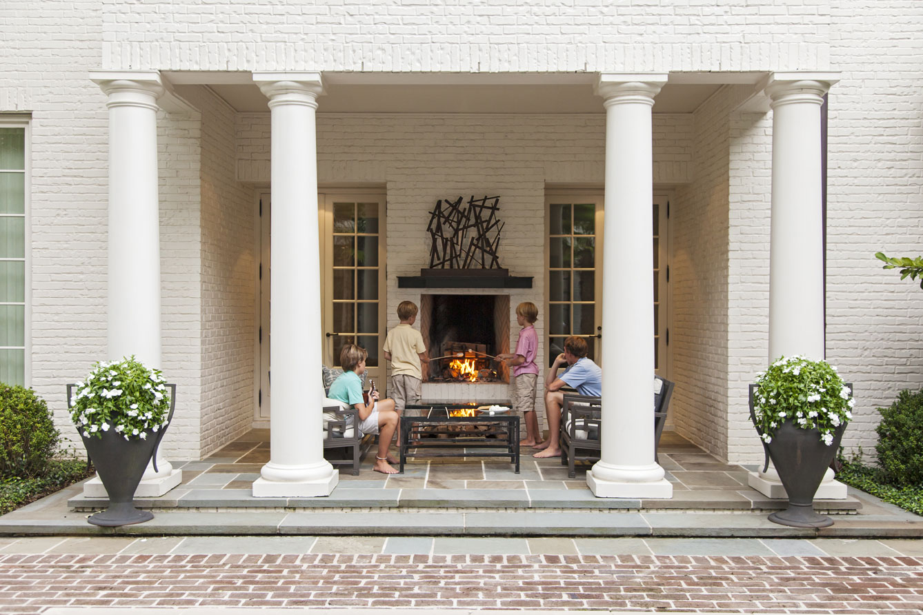 COMFORT ZONE: On fall evenings, the whole gang gathers around the outdoor fireplace to catch up on the day’s events (above).