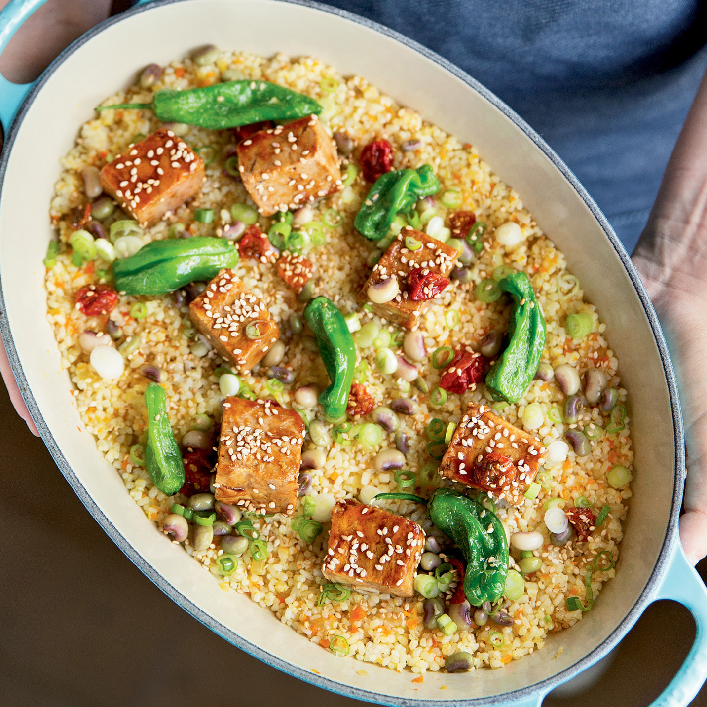 Good as Gold: Suckling pig cubes, shishito peppers, scattered butter-beans, and sprinkled benne seeds over crispy Carolina Gold rice