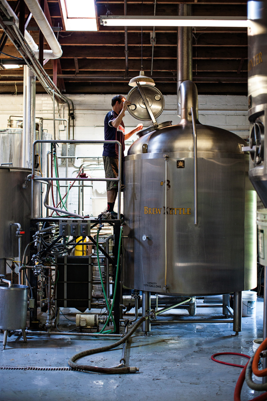 Assistant Brewer Clint Vick peers into the Brew Kettle.