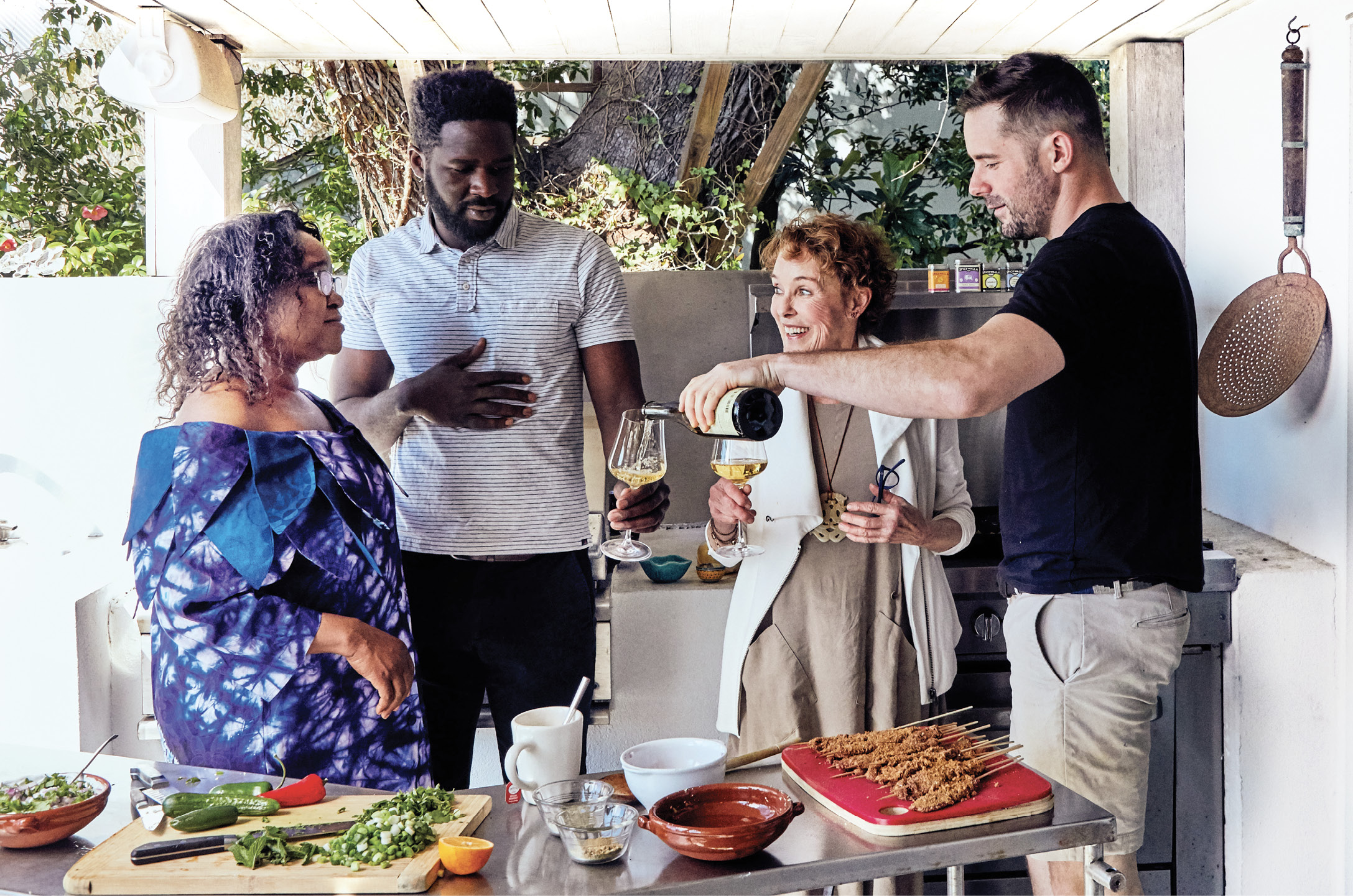 Grace Oyediran (left), visiting from Cincinnati, gets to know Miles’s mom, Callie (right), in her outdoor kitchen.