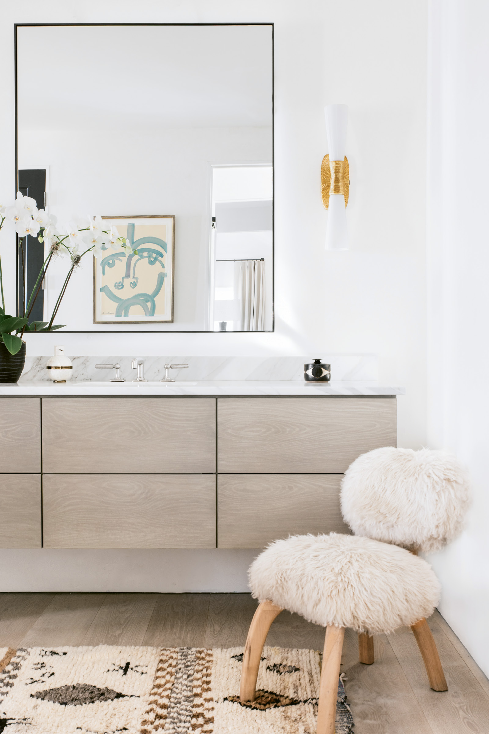 In the bath, floating custom cabinetry by Kris Kotlowski of Eurocraft Inc. echoes the cupboards in the kitchen.