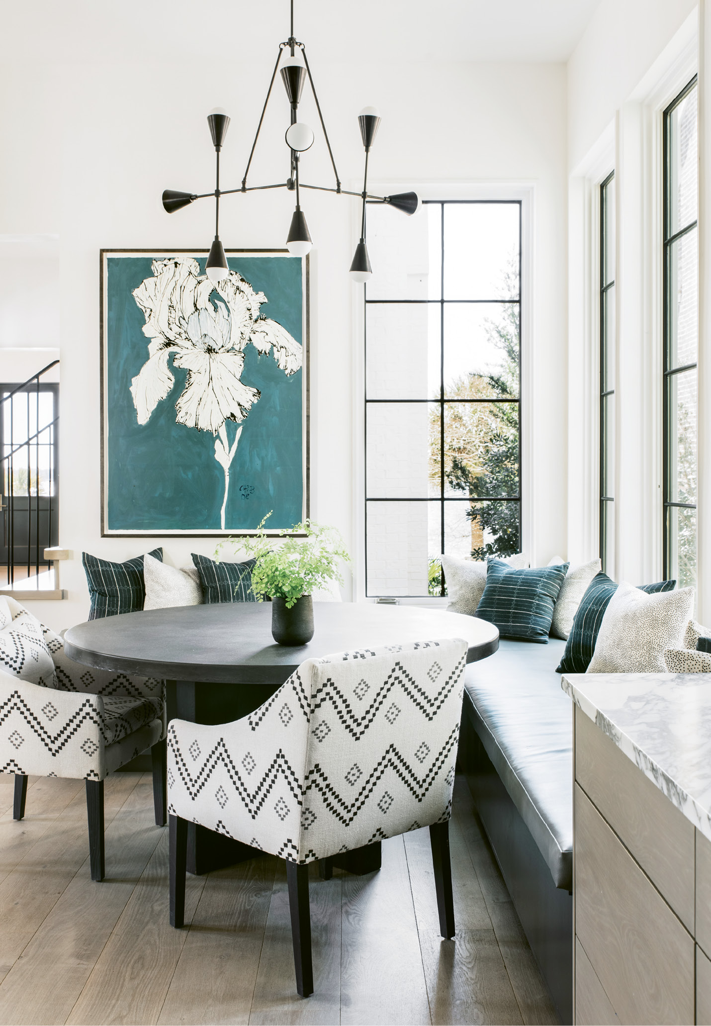 The banquette is the family hub; all gather around the concrete-topped table for meals, board games, and homework.