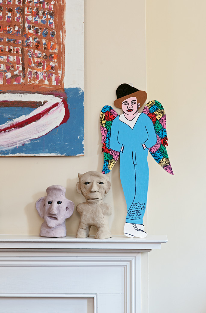 One of Scott’s favorite large-scale paintings presides over the hearth. The handiwork of his friend, the late Purvis Young, it depicts two angels watching over the Overtown neighborhood of Miami, where Young resided.