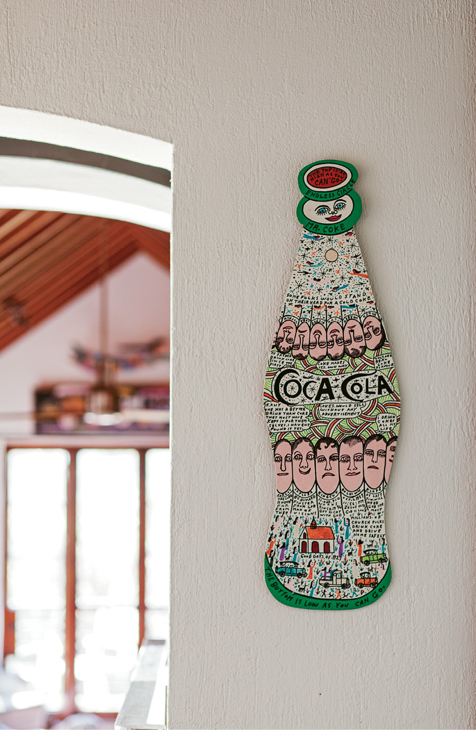 pop art: Mr. Coke (marker and acrylic on wood) by the late Georgia artist Howard Finster; his Elvis at 3 painting on plywood stands near sculptures by Burgess Dulaney of Fulton, Mississippi, on the living room mantel (opposite, bottom right).