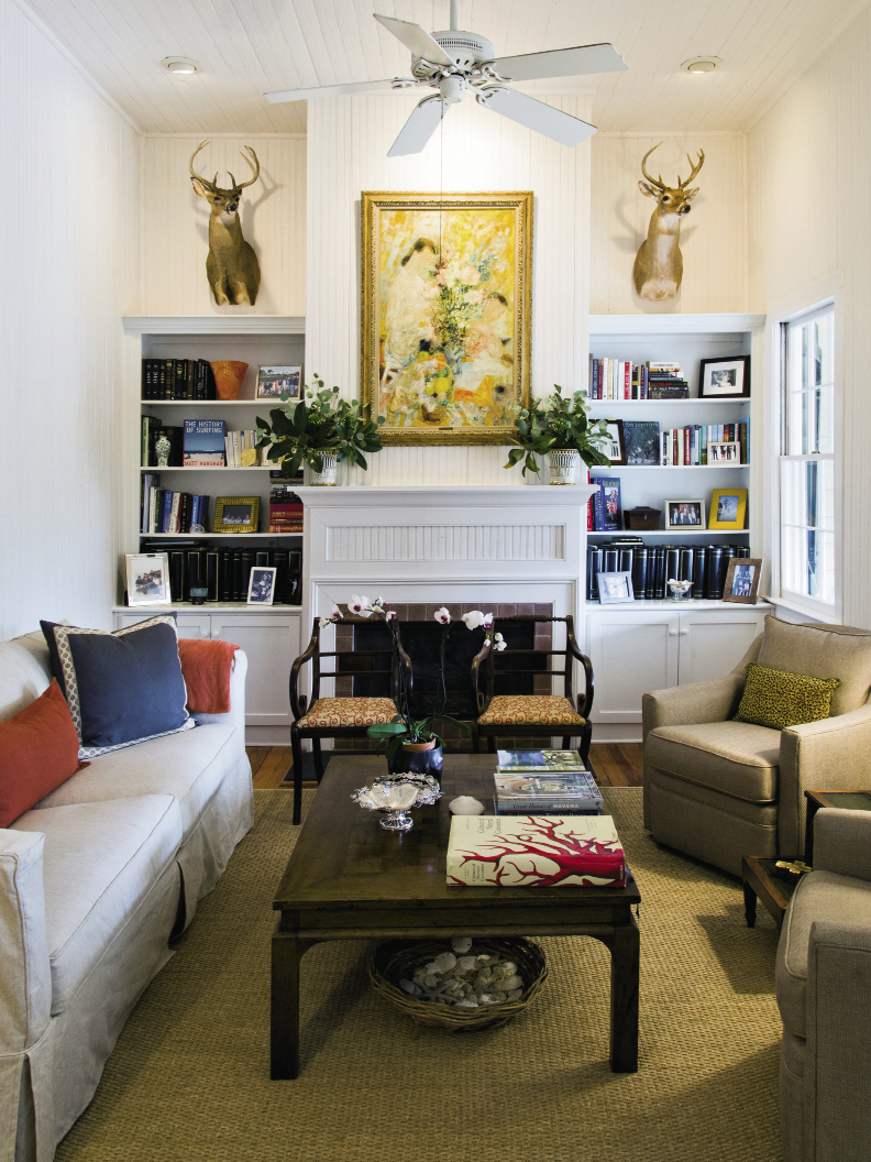 old meets new: With the help of interior stylist Nathalie Naylor, Jenny outfitted the living room with a sofa and pair of taupe chairs from Celadon, a coffee table recycled from the old house, and a pair of wooden armchairs re-covered in a fresh coral-patterned fabric.