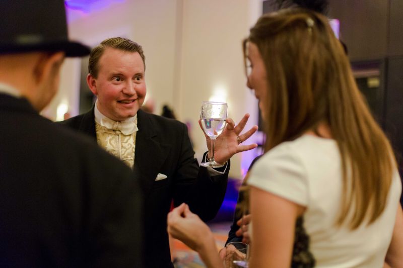 Magician Kellar O&#039;Neil performs up-close-and-personal magic, making a goldfish appear in a guest&#039;s water glass.
