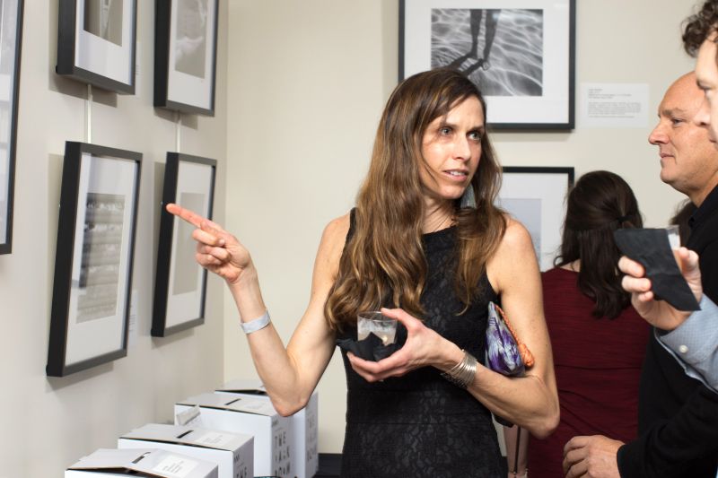 Attendees check out the black and white photographs lining the walls.